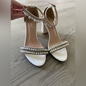 White heels with pearl accents